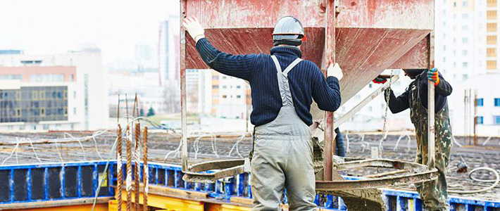 Two construction workers working
