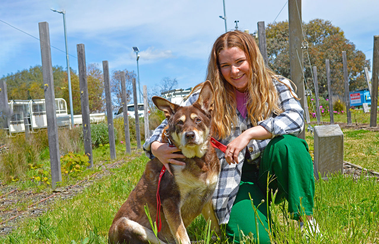 Student with dog outside