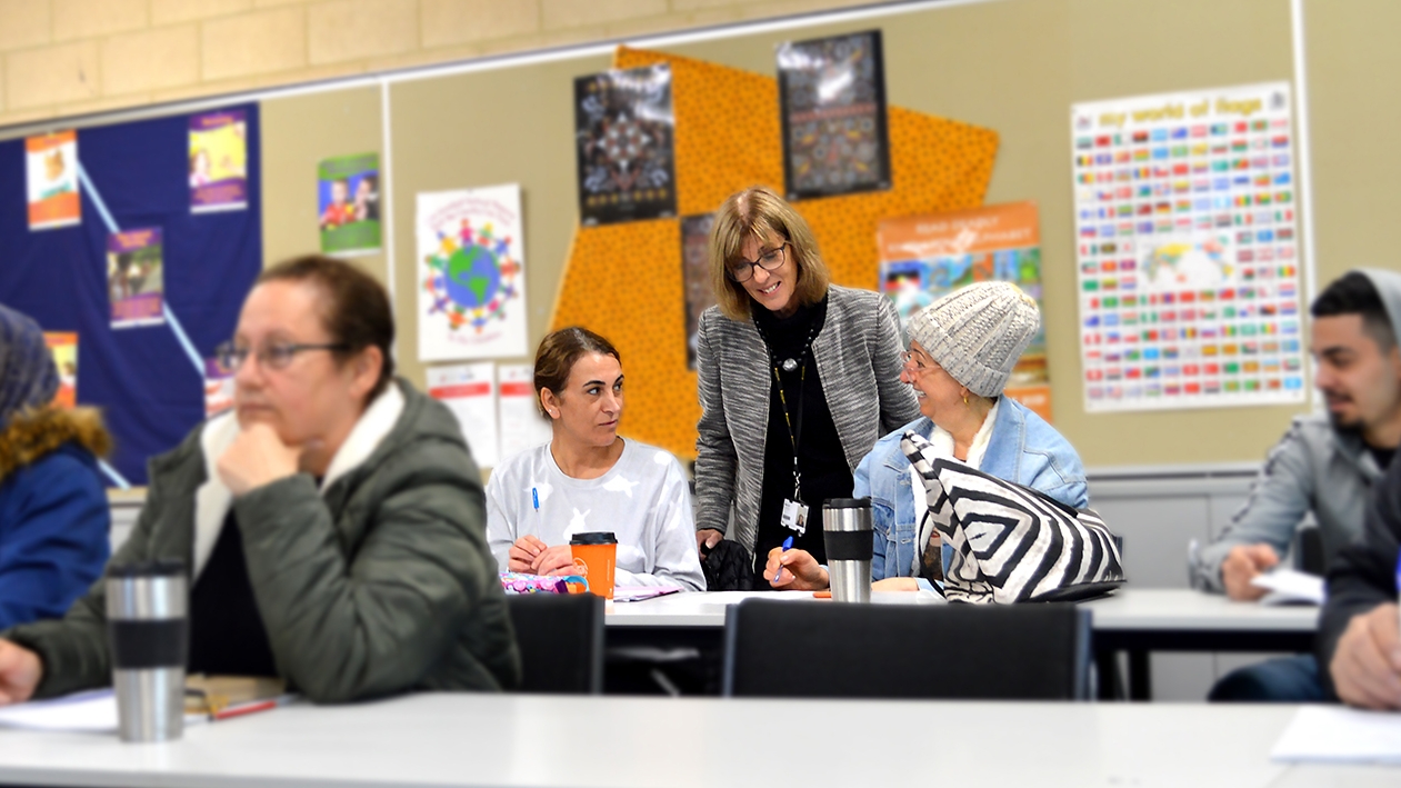 Female teacher in classroom with students