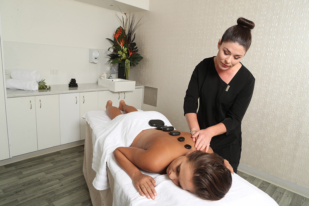 Female beauty therapy student giving a massage