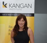 female standing infront of Kangan pull up banner