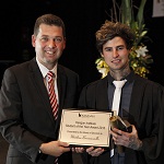 2 males holding certificate with ties