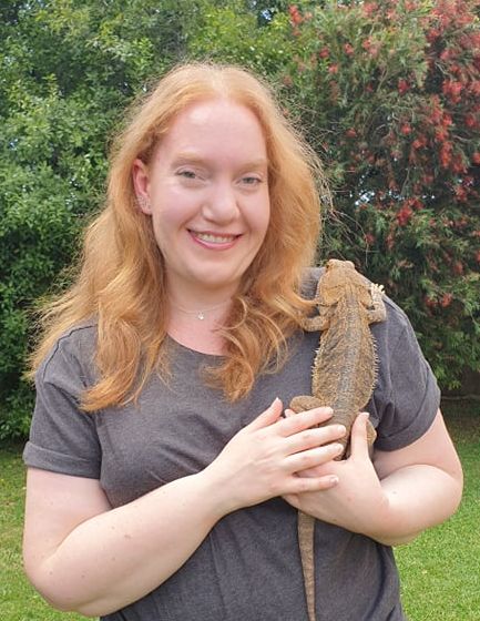 student holding the lizard