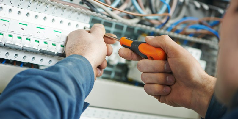 Electrician working on switchboard