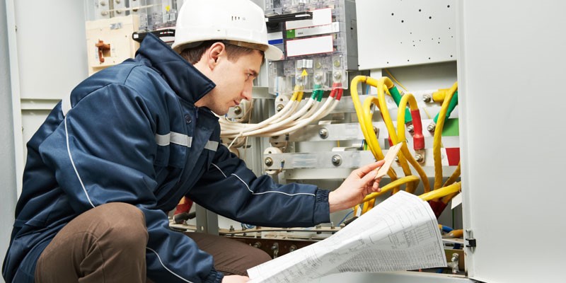 Electrician working on switchboard