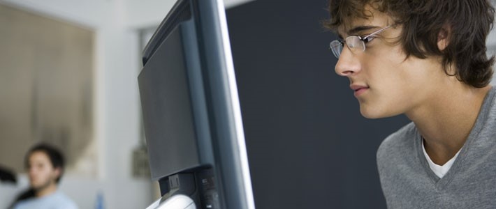 Young man looking at computer screen