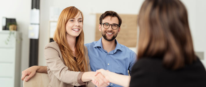 Two female smiling and shaking hand with each other 