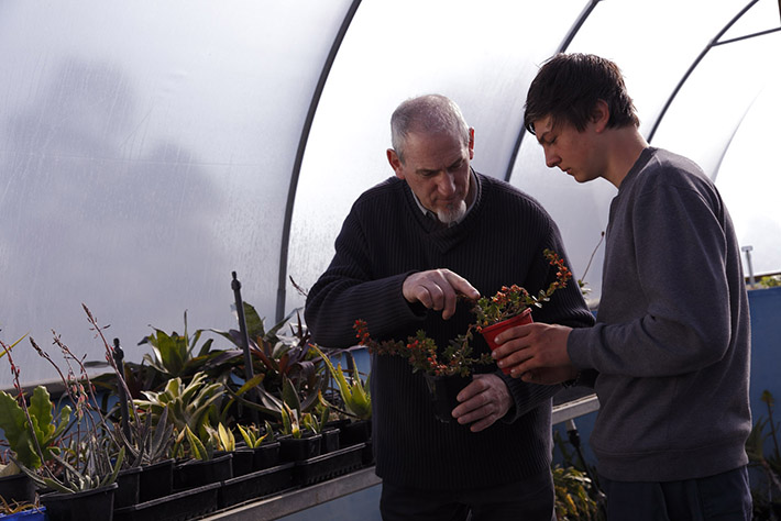 Teacher and student in greenhouse