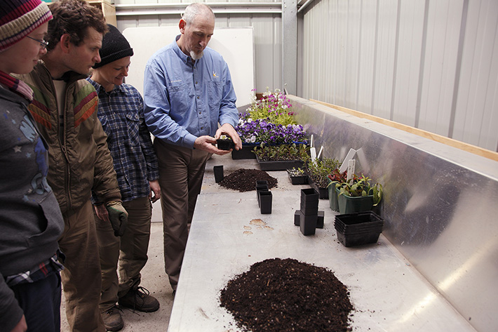 Teacher and students in potting shed