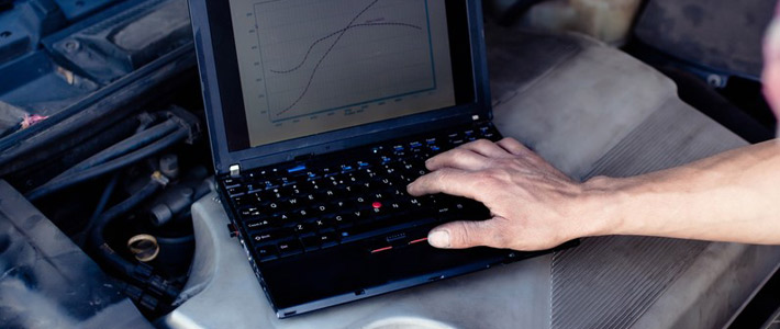 Laptop computer sitting on engine bay