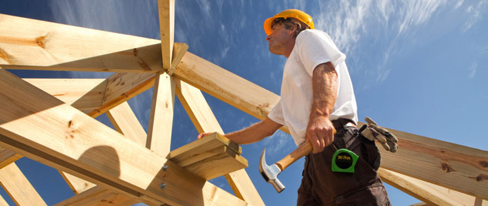 Builder examining roof frame
