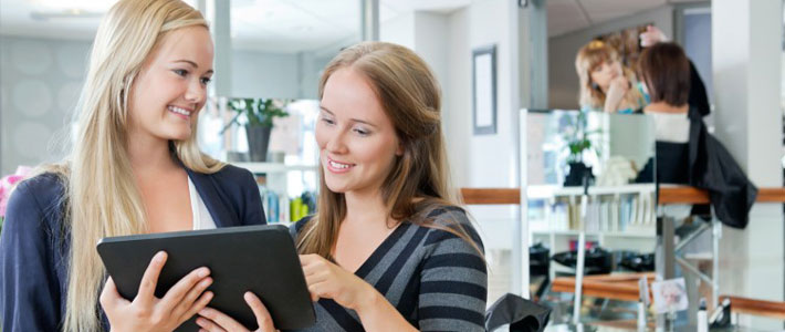 Hairdressing salon workers with digital tablet