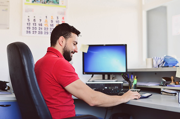 Man sitting at computer desk in office