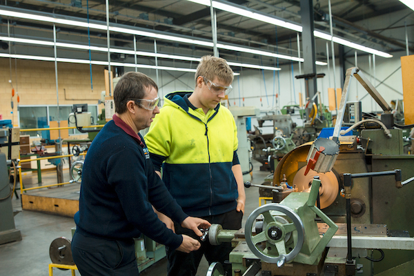 Male teacher with male engineering student