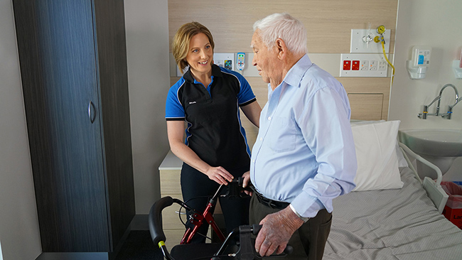 Female Health Care worker helping elderly man
