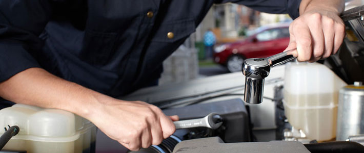 Hands holding automotive tools