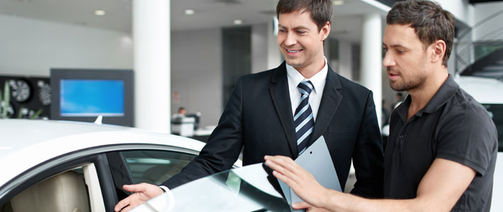 Car salesman with customer