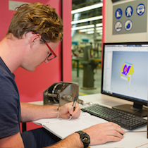 Male drawing in front of computer screen 