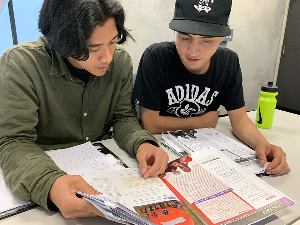 male students reading in classroom