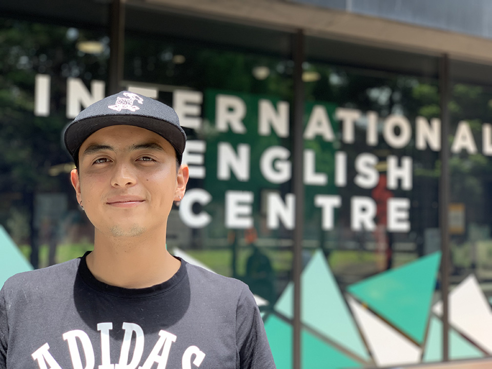 Male student standing outside of school