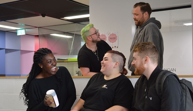 Group of people sitting together and laughing