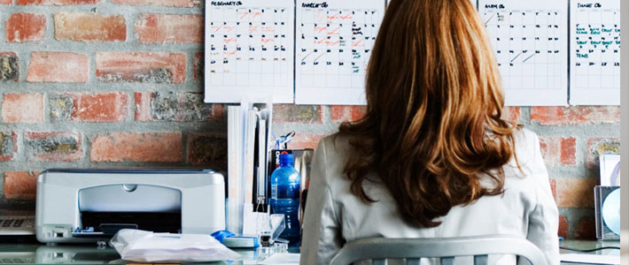 back of female sitting at a desk studying 