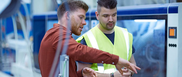 Two workers assessing the safety of their equipment