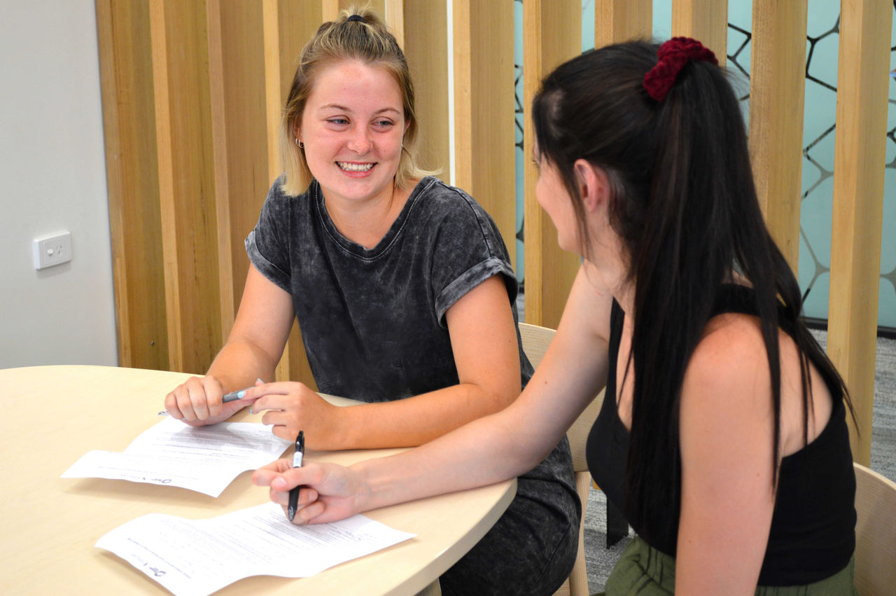 Two female students sitting at the table