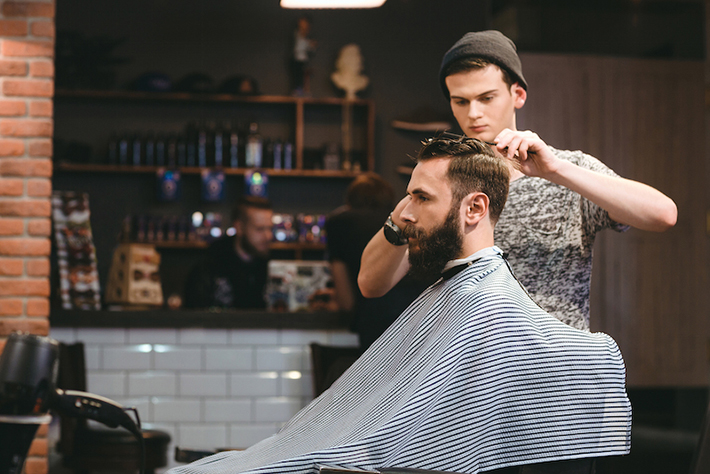 Male barber styling a clients hair
