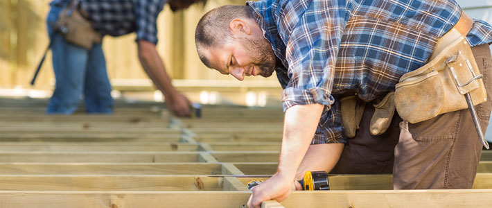 Construction worker building sub-floor