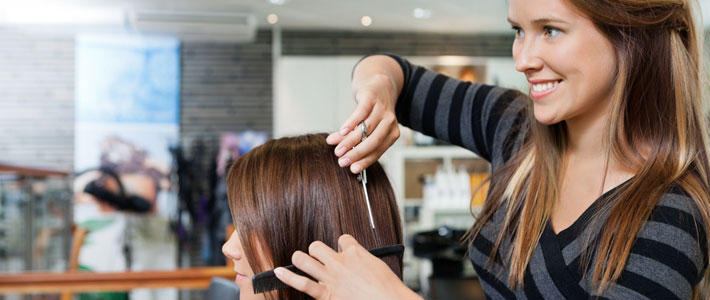 Hairdresser trimming hair