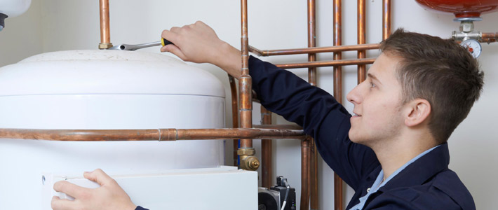 Plumber working on hot water storage