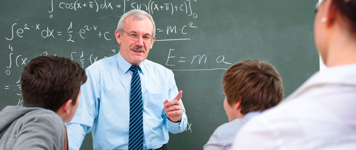 Mature male teacher in front of teenage students