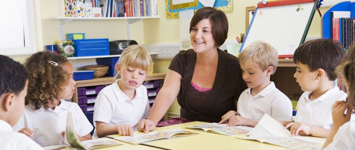 Female teacher with young children in a classroom