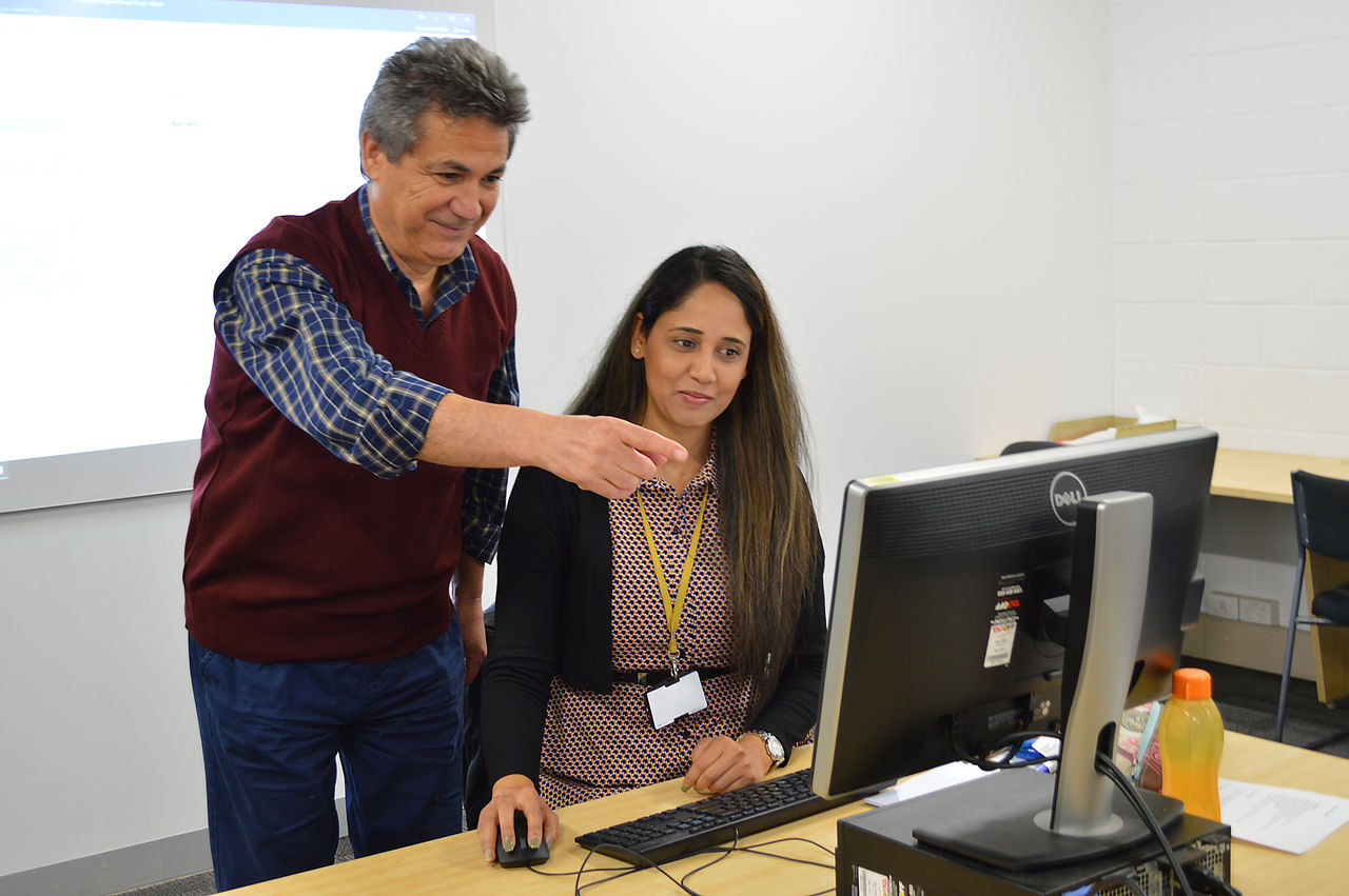 Mature male teacher in front of teenage students