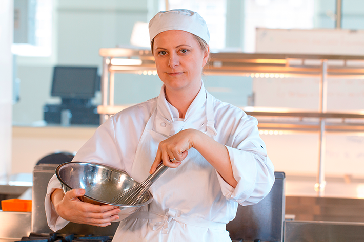 Kitchen worker mixing ingredients